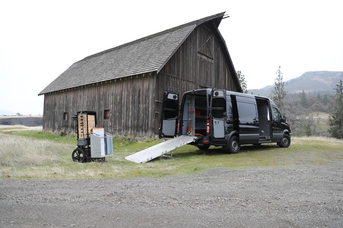 Ramp down, carts unloading from the back of the van